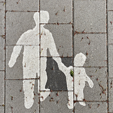 Adult with a child chalk outline on bricks